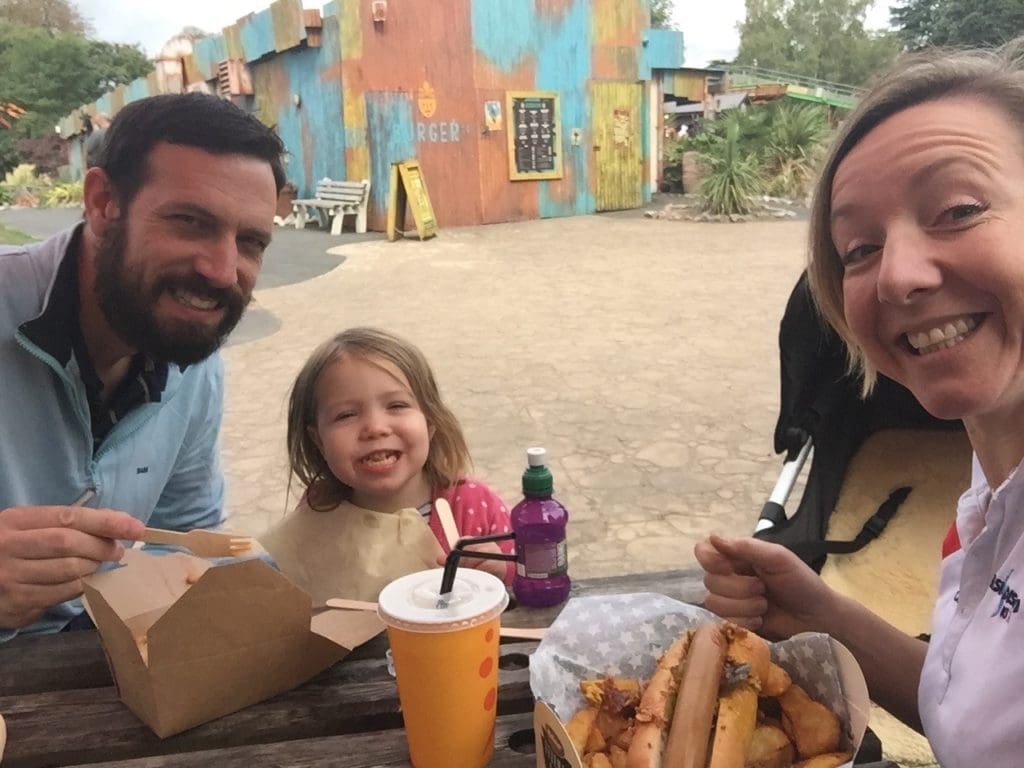 Anna (left) having lunch with her husband and young daughter