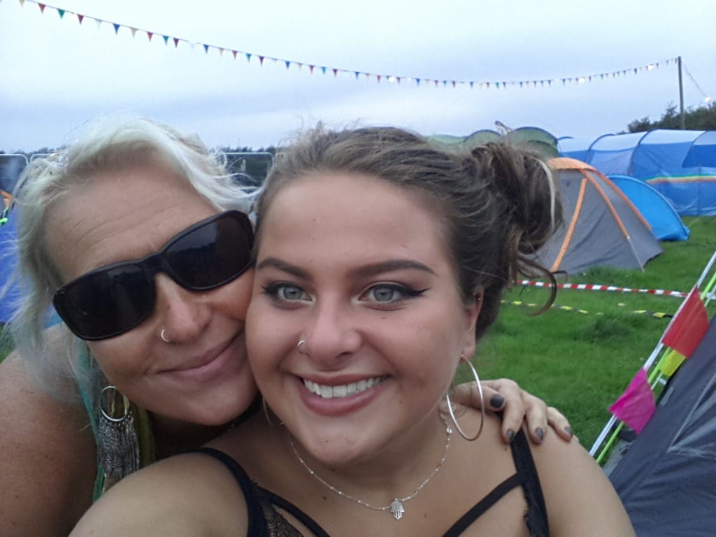 Maisie and her mother Michelle smiling at a festival