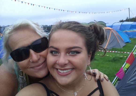 Maisie and her mother Michelle smiling at a festival