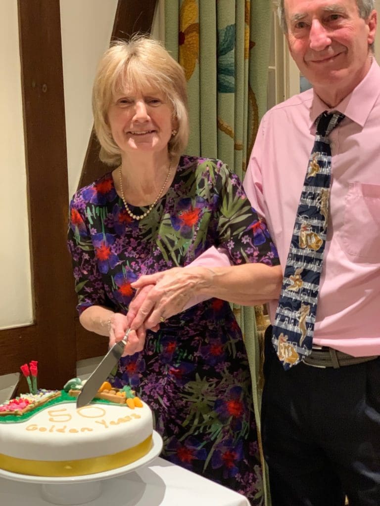 Alan and Sandra cutting their 50th wedding anniversary cake