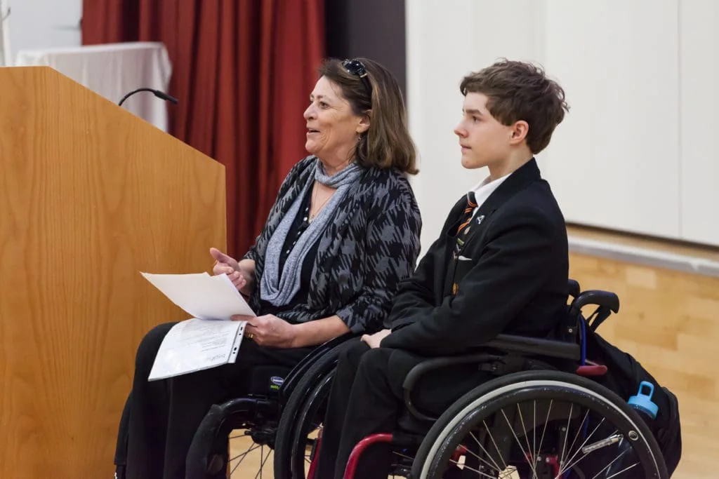 An education advocate and student - both with a spinal cord injury - giving a presentation to the school community