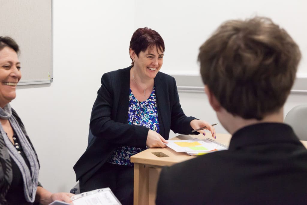 Kevin, one of our young volunteers, in a meeting with a member of staff at his school