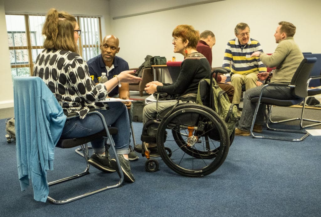 A group of volunteers talking at our mentor training in January 2017