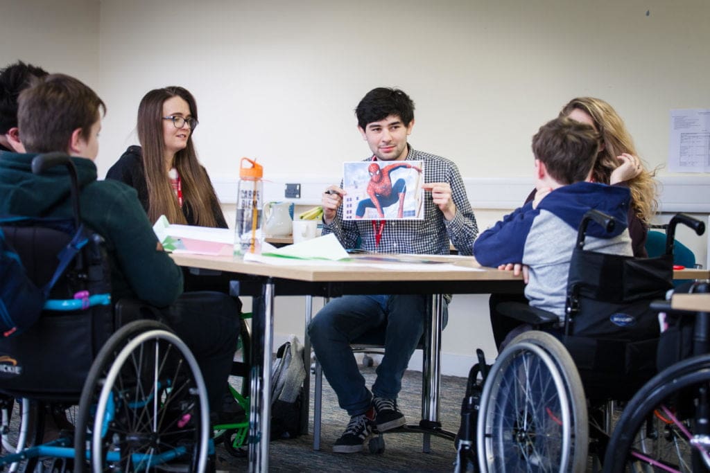 Young wheelchair users and volunteers at a training weekend