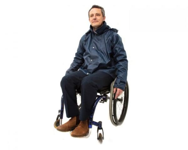 Wheelchair user wearing a navy waterproof jacket