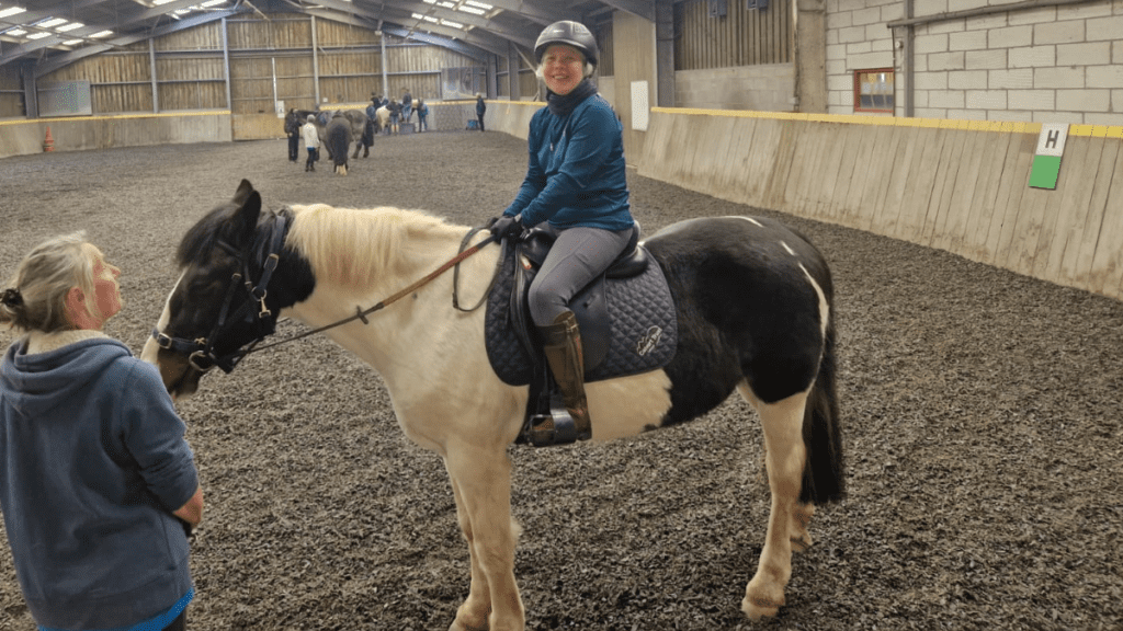 Tina, who back up helped with independence after spinal cord injury, riding a horse on one of our multi activity courses