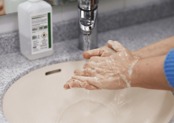 a person washing hands in line with coronavirus advice.