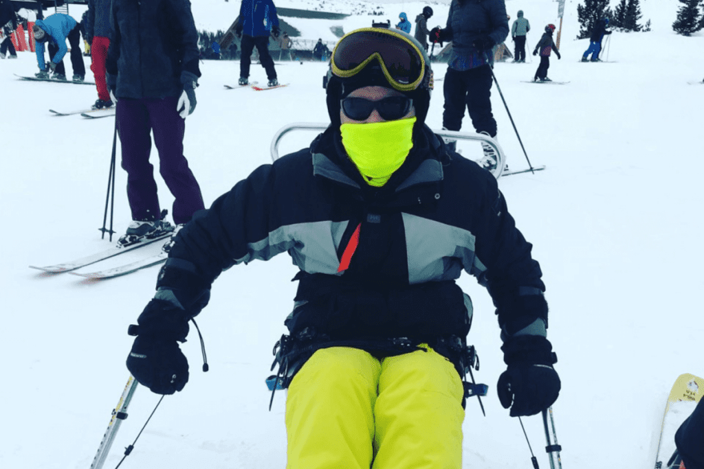 Ian using a sit ski during some travel after spinal cord injury