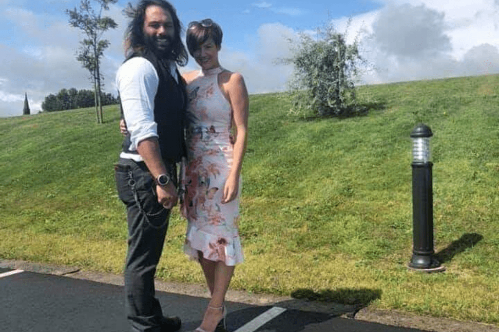 Adrian posing with his wife Louise in a car park