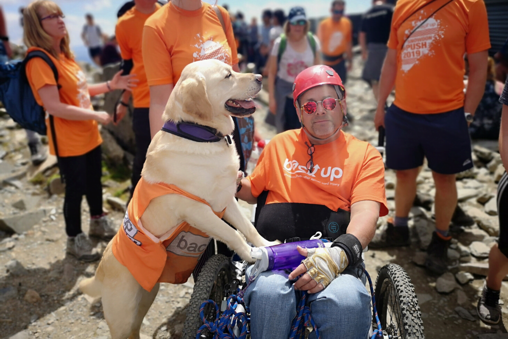 Tim with his dog Elliot on top of Mount snowdon while taking on the Snowdon Push challenge