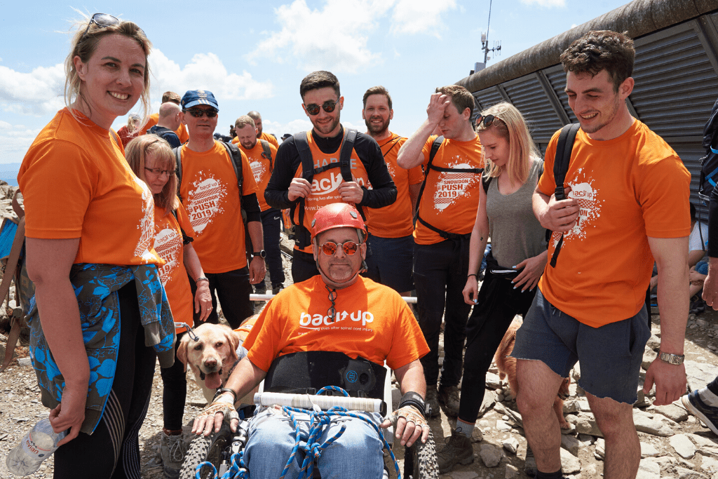 Tim and his family at the summit of mount snowdon after completing our Snowdon Push challenge