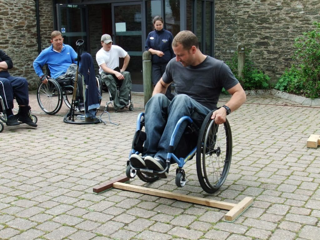 A volunteer wheelchair user leading a skills session on a course