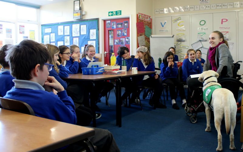 Education advocate giving talk to primary school children