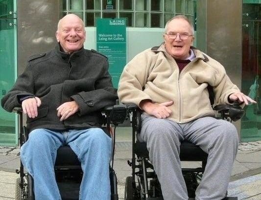 two happy elderly gent wheelchair users