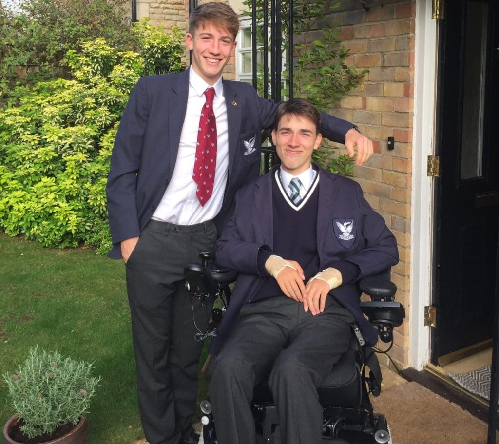 George posing with his brother wearing his school uniform, ready to get back into school