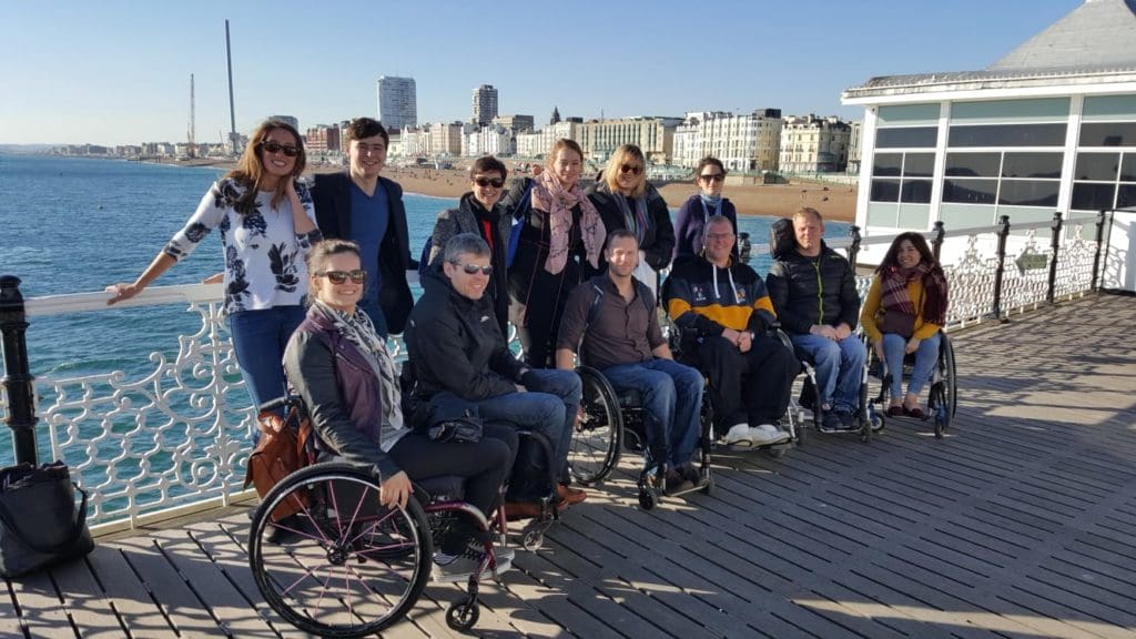 Merryn and the services team at Brighton pier on a sunny day.