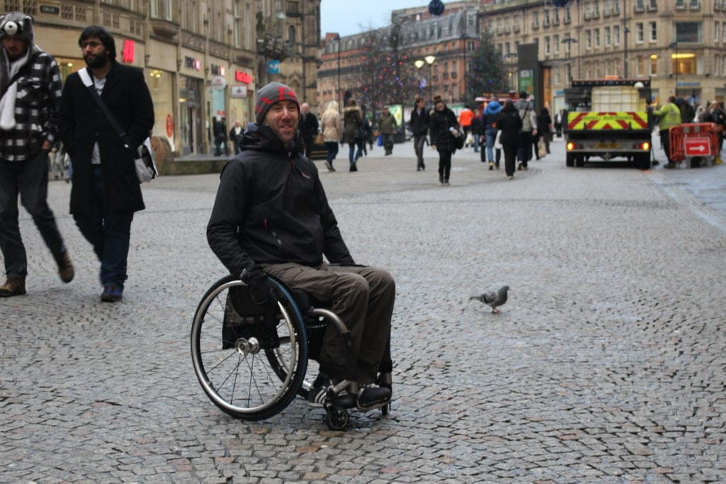 Wheelchair user in a busy City