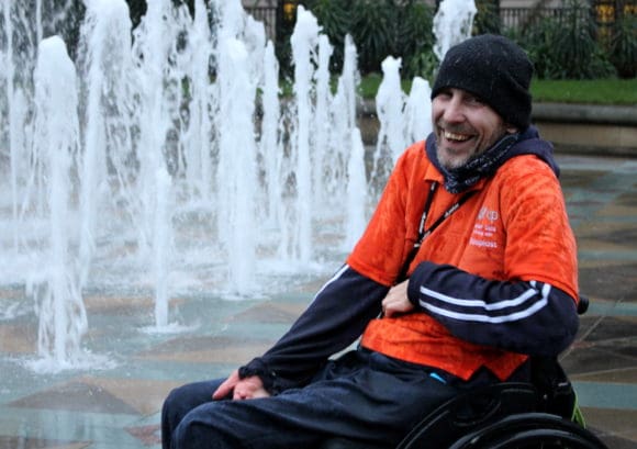 A wheelchair skills trainer outside a fountain