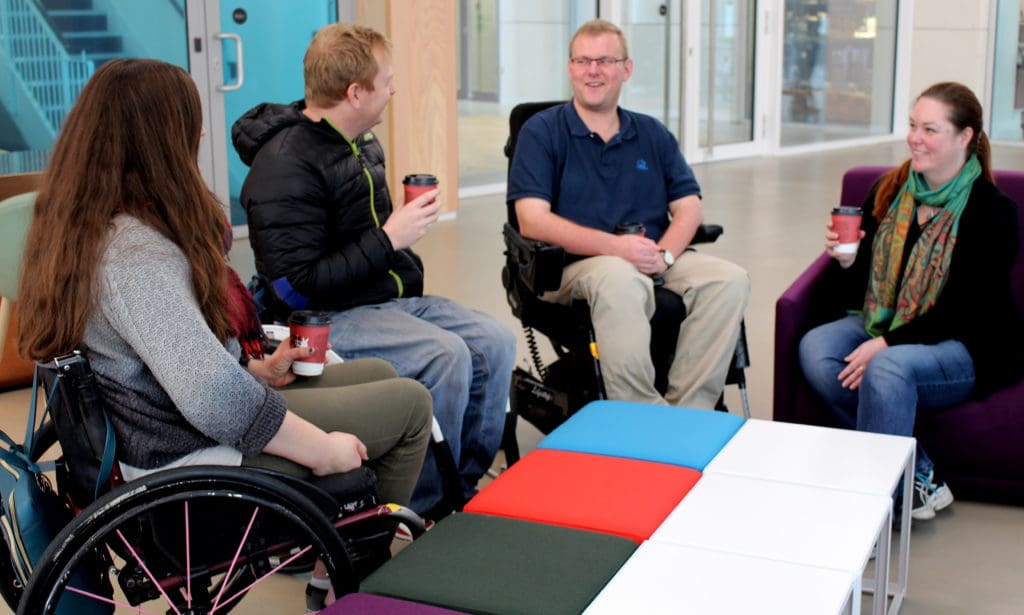 group of people with a spinal cord injury chat about taking care of their emotional wellbeing