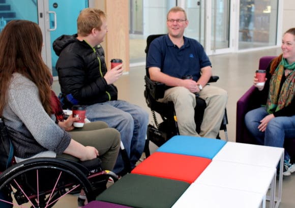 group of people with a spinal cord injury chat about taking care of their emotional wellbeing