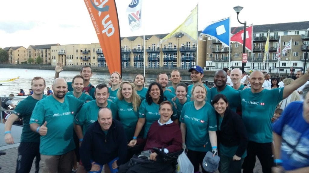 Andy and his colleagues smiling and laughing at the Dragon Boat Race