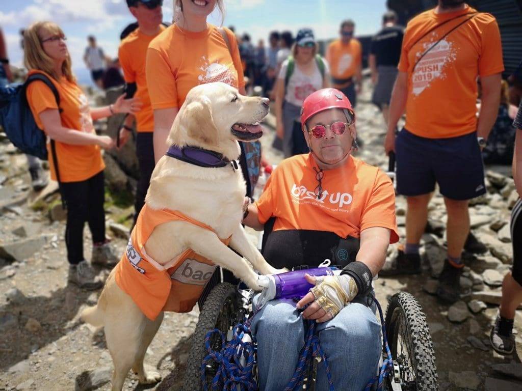 Our dear friend and volunteer, Tim Scott, at the top of Mount Snowdon with his assistance dog