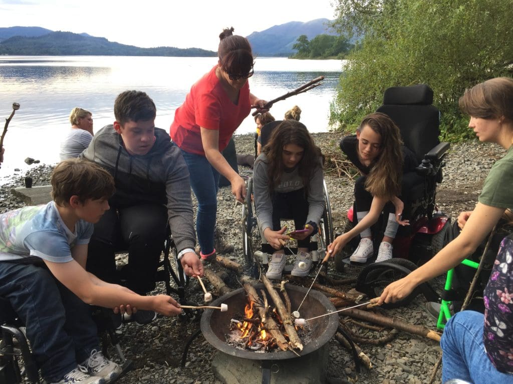 Tom making a campfire with friends on the 13-17s multi-activity course