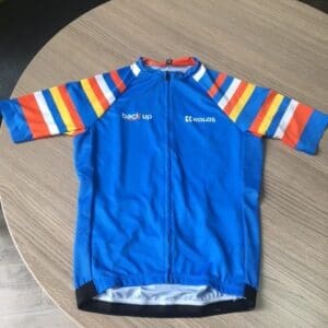 Front of a blue #NoLimits cycling jersey with stripes on the sleeves