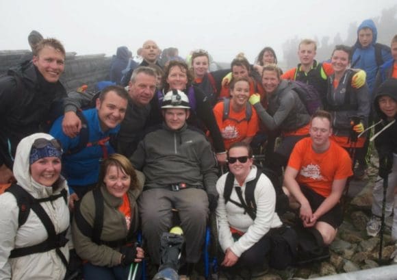 Joe at the top of Mount Snowdon with his Snowdon Push team