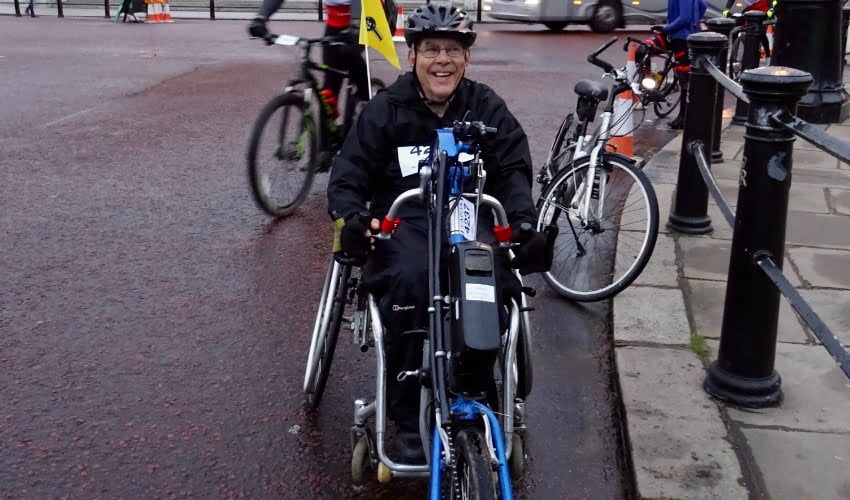 John handcycling to maintain his independence over time