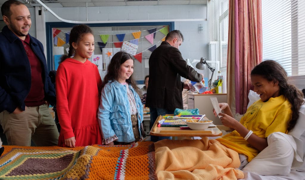 Katy being visited in hospital by her family