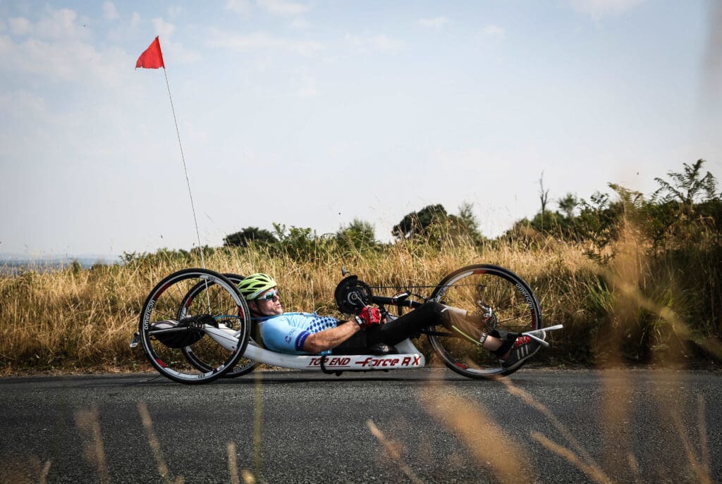 Ian hand cycling on a country road for our vital services