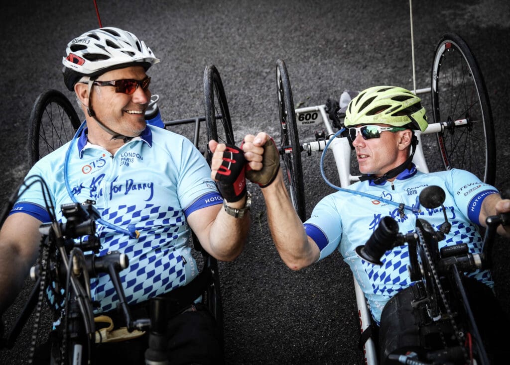 Ian and another participant take a moment to fist-bump while tackling the no Limits #Ridefordanny hand cycling challenge