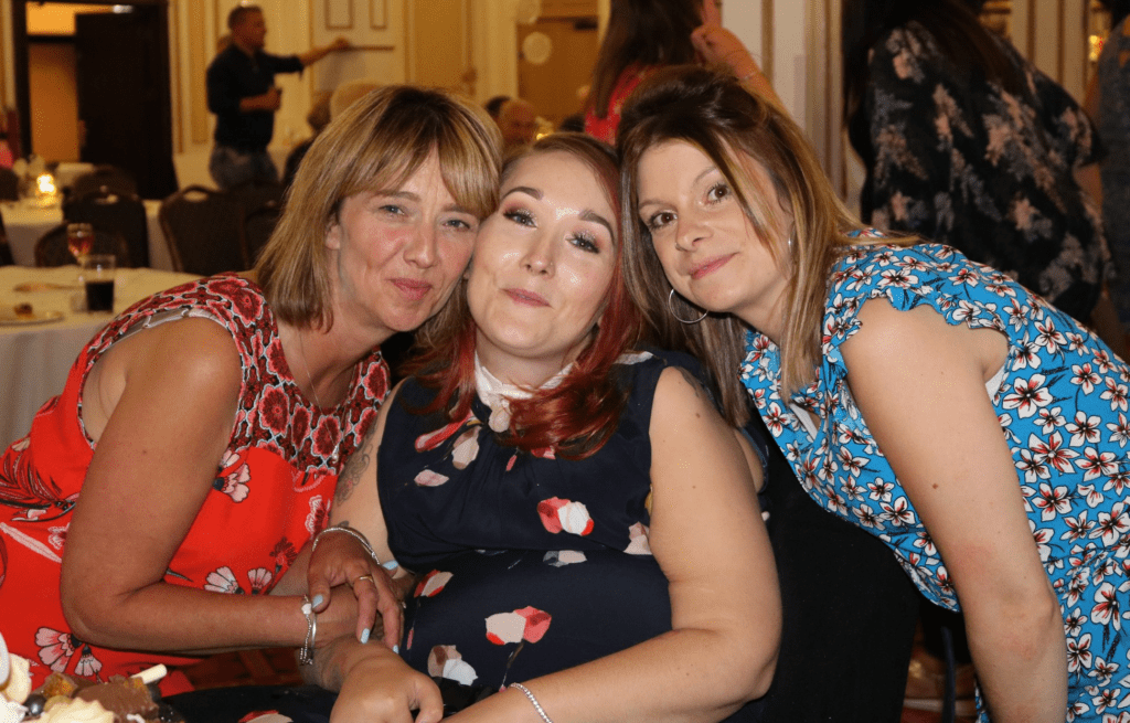 Supporter Lauren in between two friends at her 30th birthday party