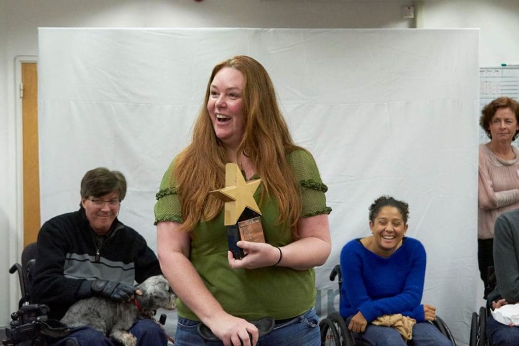 Kim, a Back Up volunteer, receives her Volunteer of the Year award