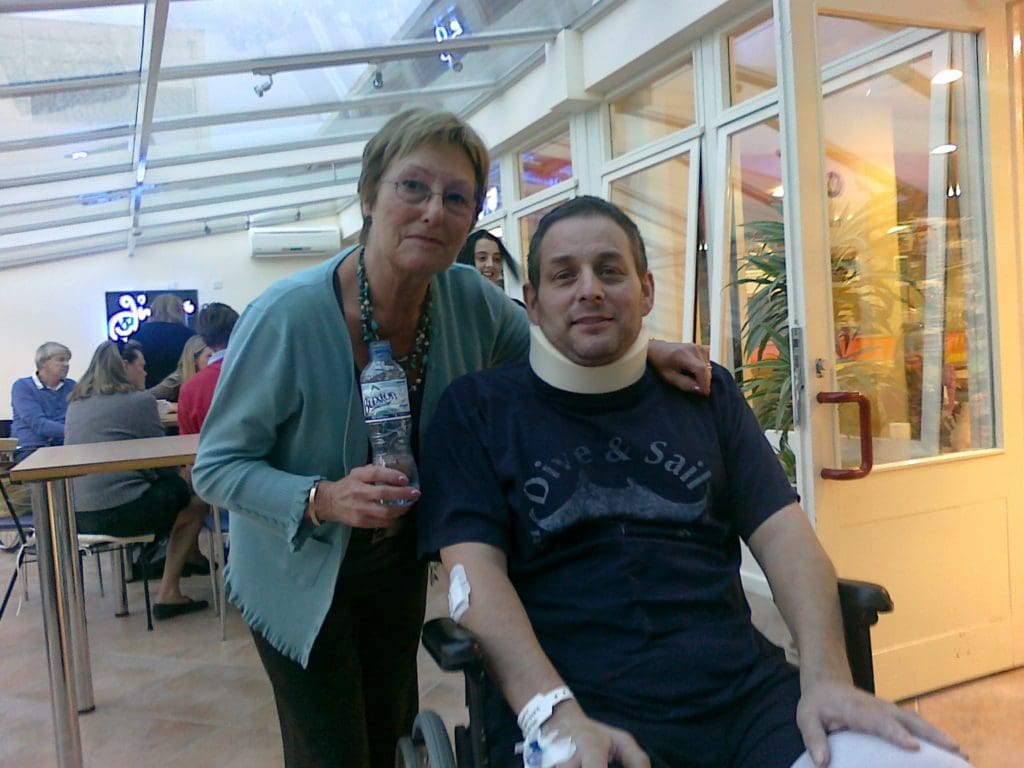 Photo of Tim with his mum at hospital for his 'Learning to adjust' story