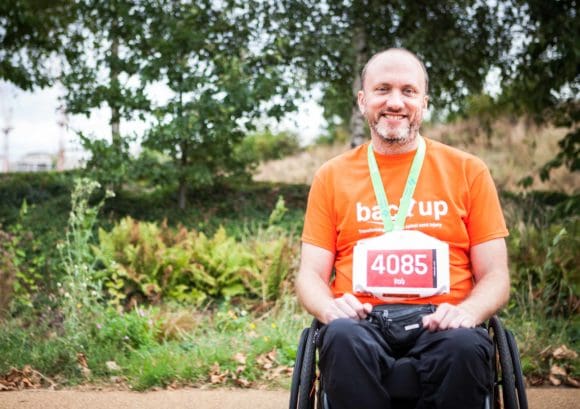 Wheelchair user with medal at a fundraising challenge