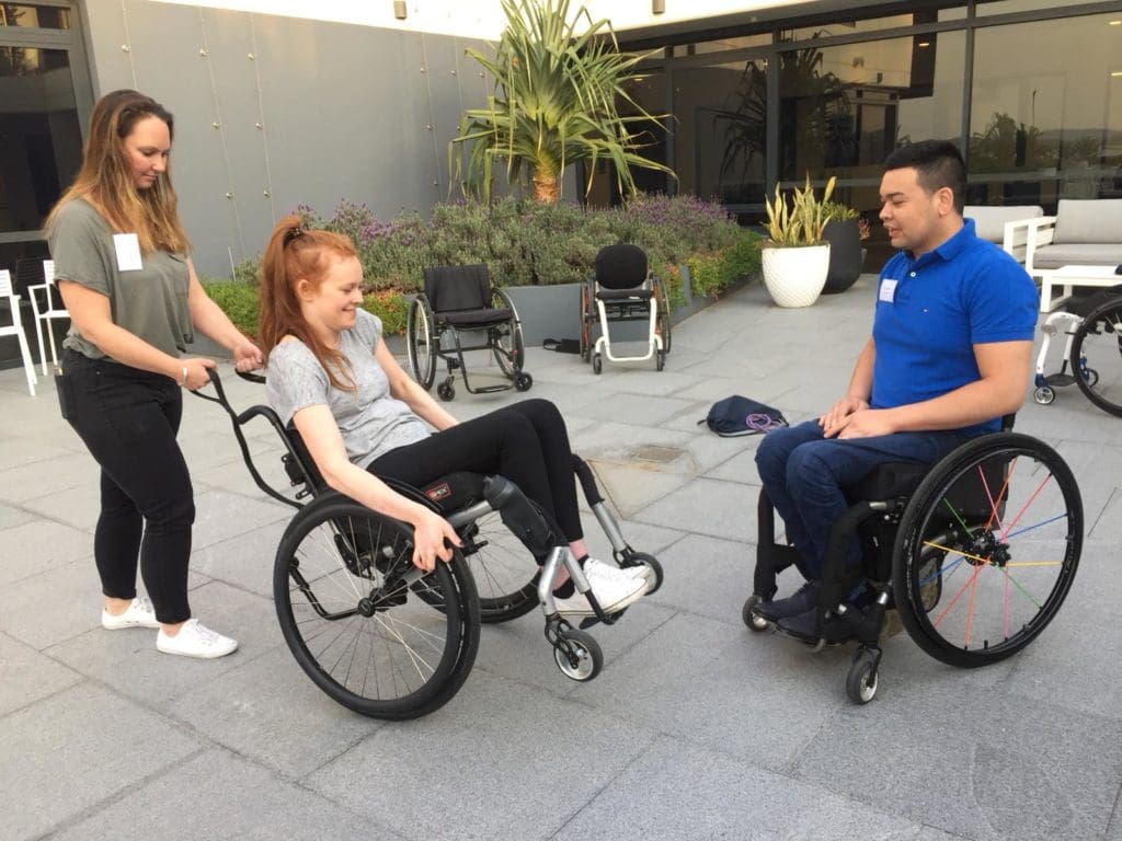 Participant on our mini couse in Australia practising a back wheel balance with a spotter