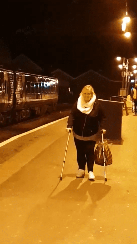 Fiona walking with aids after being discharged from the spinal centre