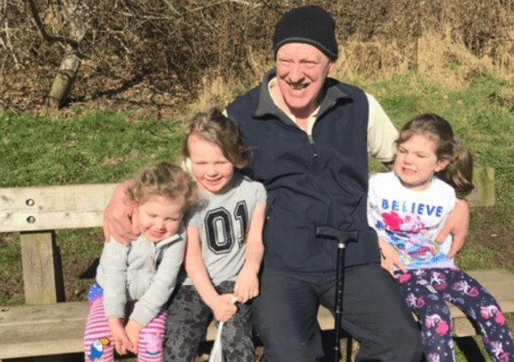 tom, a man who regained his independence after spinal cord injury,, sitting with his family