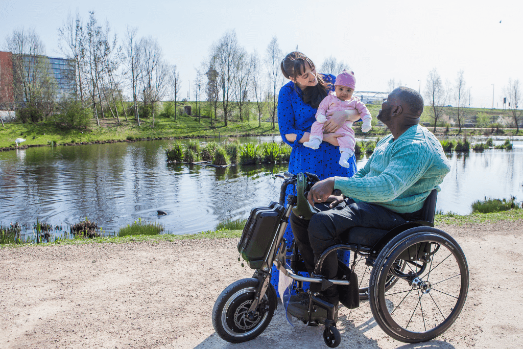 Shaun, with his wife and new baby beside a lake