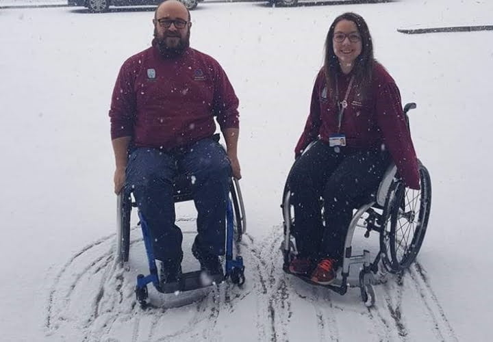 Photo of two Millbrook Healthcare staff members taking on the wheelchair challenge