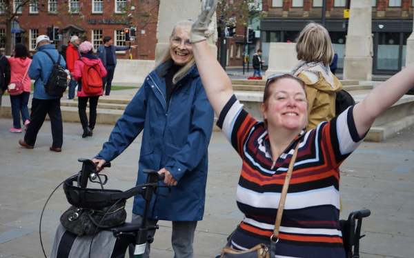 Two of our participants, one a wheelchair user and one walking with the aid of a frame, exploring the centre of manchester