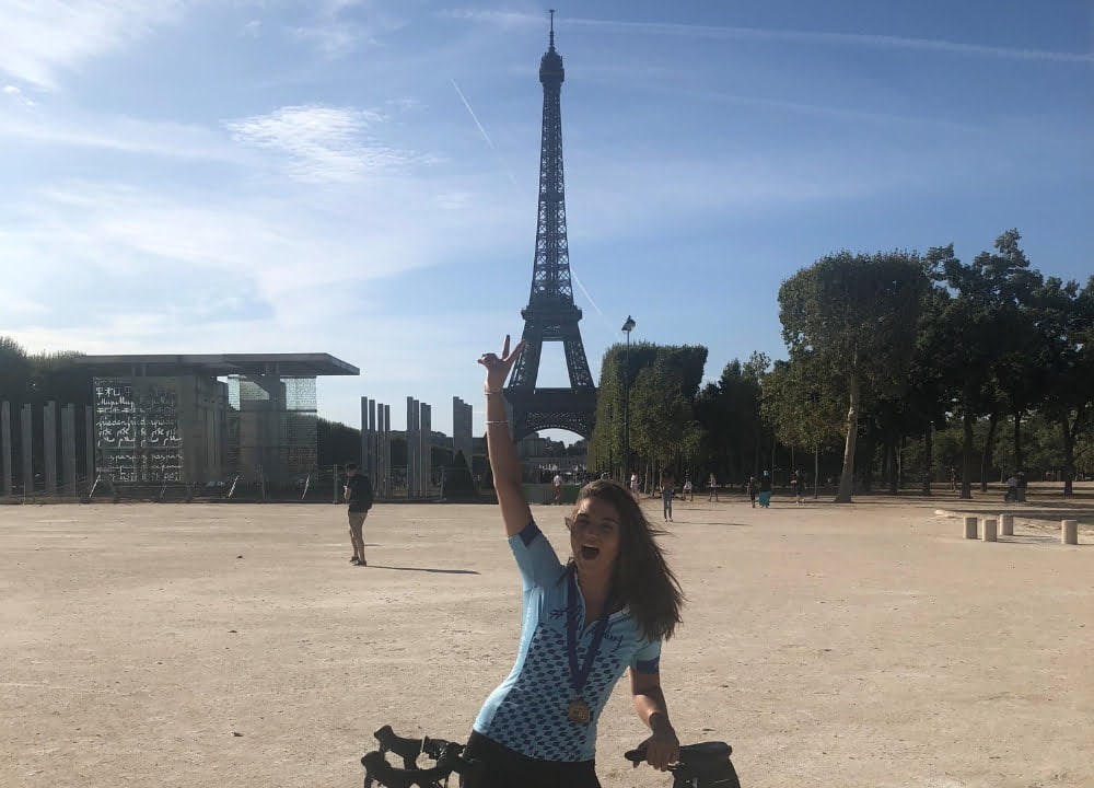 Lauren celebrating in front of the Eiffel Tower after completing the #RideforDanny cycling challenge 