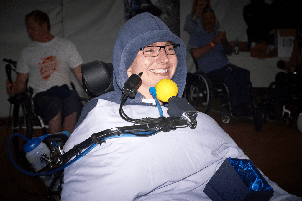 Peter, a chin controlled power chair user, grinning after winning the "spirit of the push" award at our annual Snowdon Push challenge.