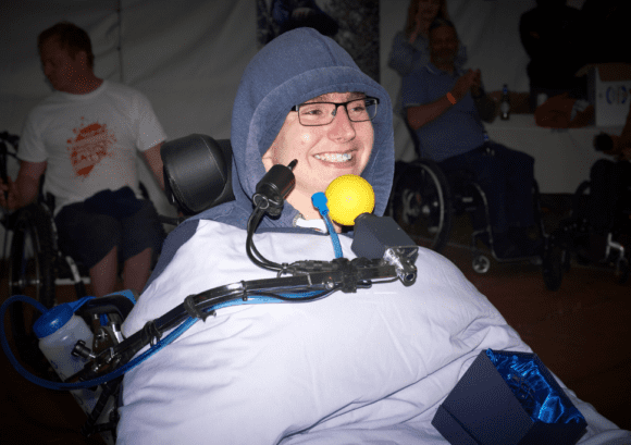 Peter, a chin controlled power chair user, grinning after winning the "spirit of the push" award at our annual Snowdon Push challenge.