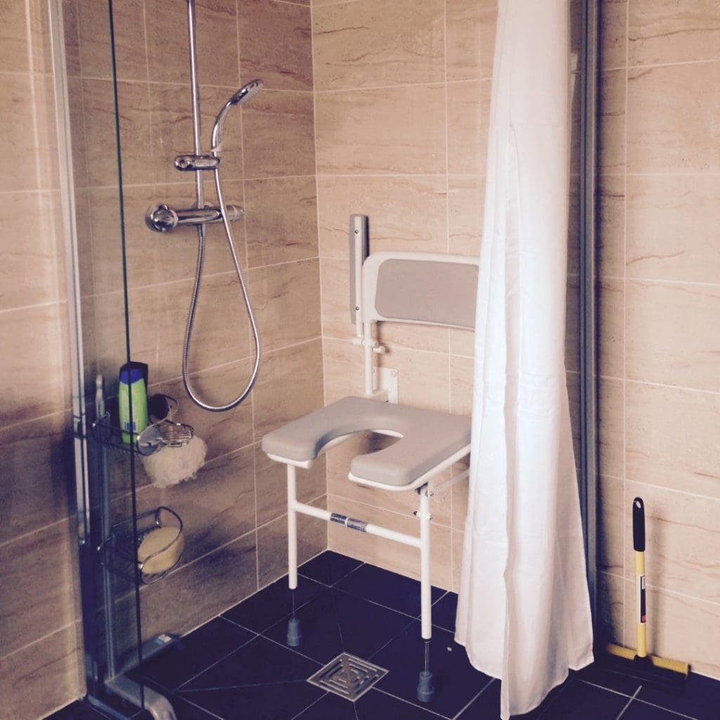 A photo of Roger's bathroom, adapted with a shower seat so he can shower independently.