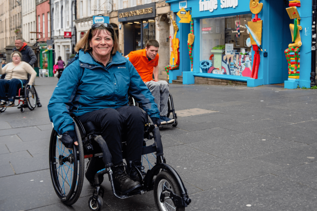 Julie, who has been a Back Up volunteer ofr 30 years, pushing up a street