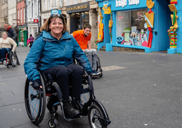 Julie, who has been a Back Up volunteer ofr 30 years, pushing up a street