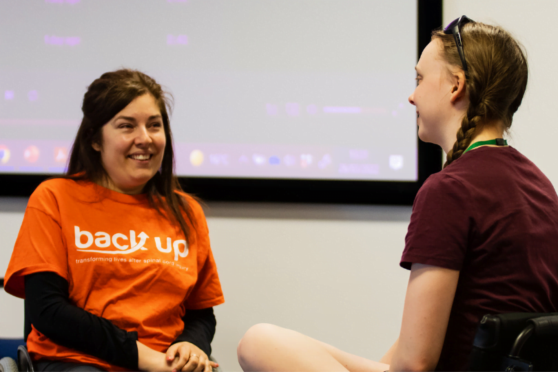 Two women smiling in a conversation